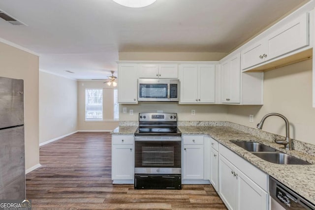 kitchen with sink, dark hardwood / wood-style floors, white cabinets, and appliances with stainless steel finishes