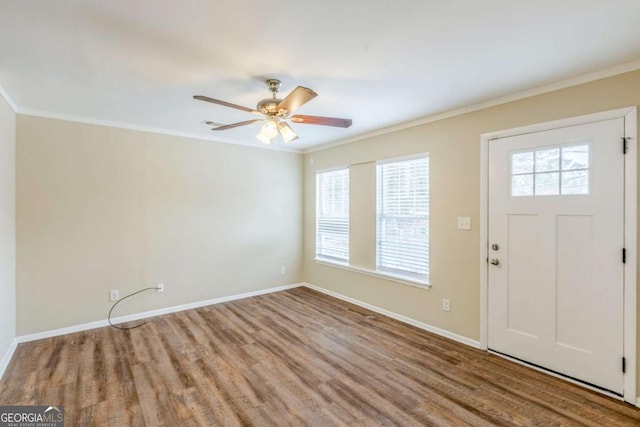 entrance foyer with crown molding, light wood-type flooring, and ceiling fan