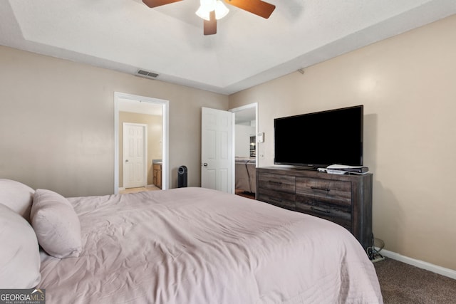 bedroom with connected bathroom, ceiling fan, and carpet flooring