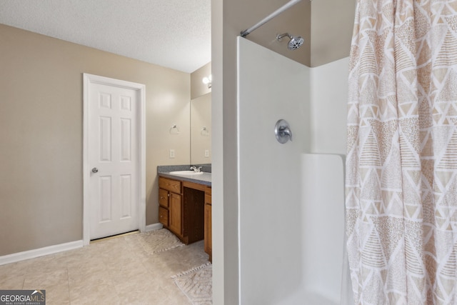 bathroom with vanity, a textured ceiling, and a shower with curtain