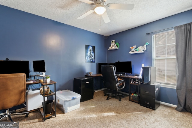 office space featuring ceiling fan, light colored carpet, and a textured ceiling