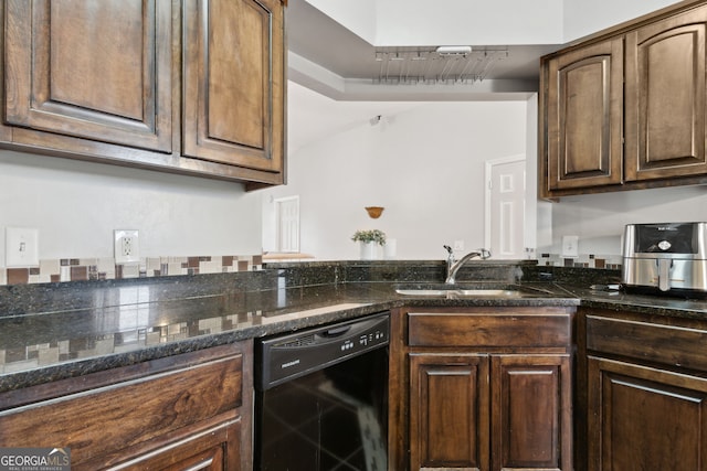 kitchen featuring dark stone countertops, dark brown cabinets, black dishwasher, and sink