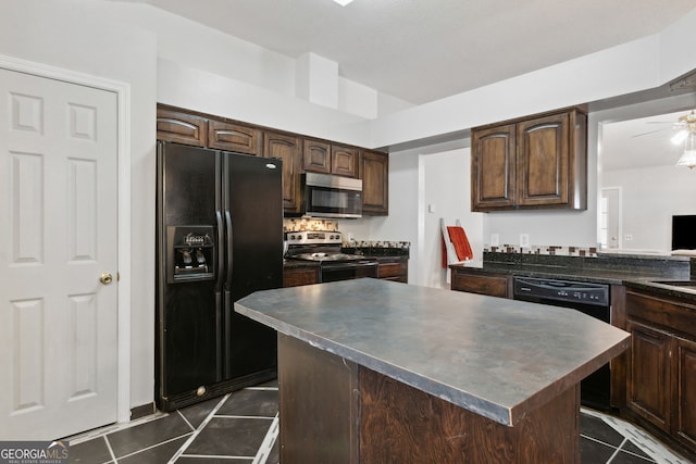 kitchen featuring dark brown cabinetry, dark tile patterned flooring, black appliances, and a kitchen island