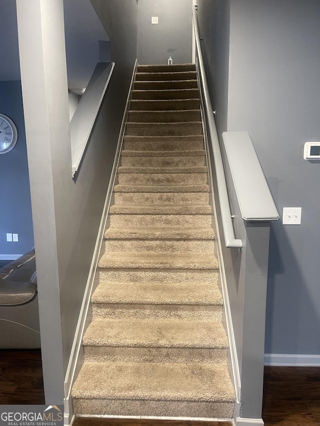 stairway featuring hardwood / wood-style flooring