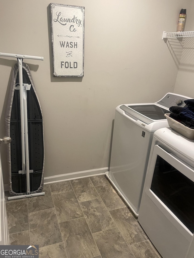 laundry room with washing machine and clothes dryer