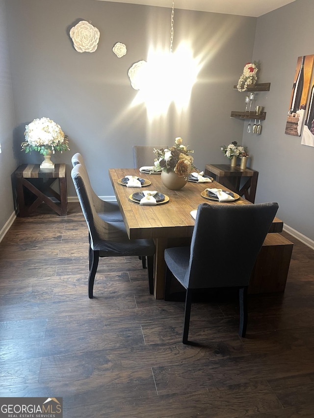 dining space with dark hardwood / wood-style floors