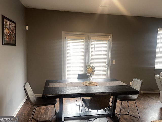 dining space with dark hardwood / wood-style flooring