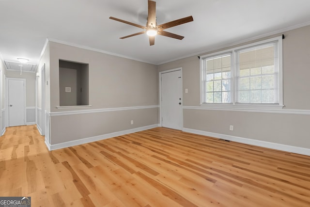 spare room featuring crown molding, ceiling fan, and light wood-type flooring