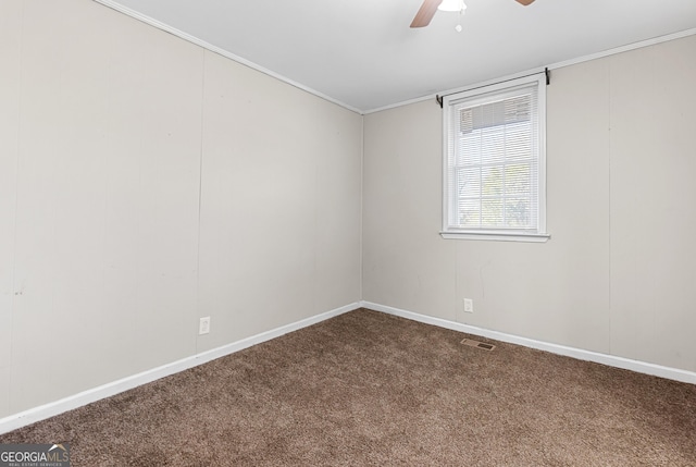 carpeted empty room with ornamental molding and ceiling fan