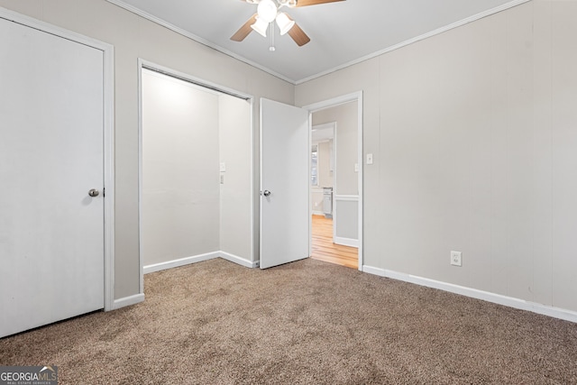 unfurnished bedroom featuring ornamental molding, carpet flooring, and ceiling fan