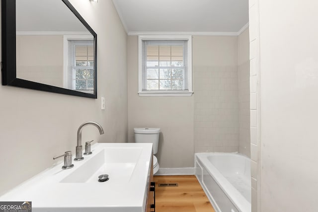 full bathroom with hardwood / wood-style flooring, shower / bath combination, vanity, ornamental molding, and toilet