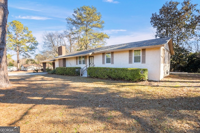 ranch-style house with a front lawn