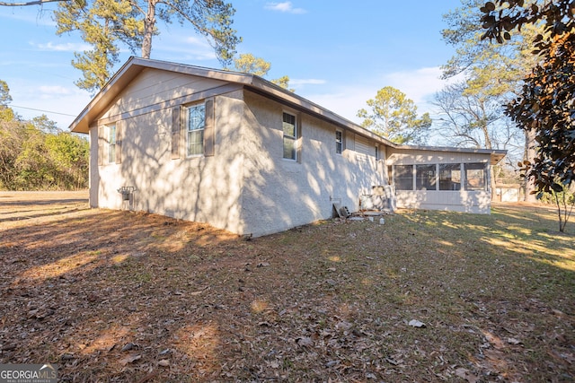 back of property with a sunroom