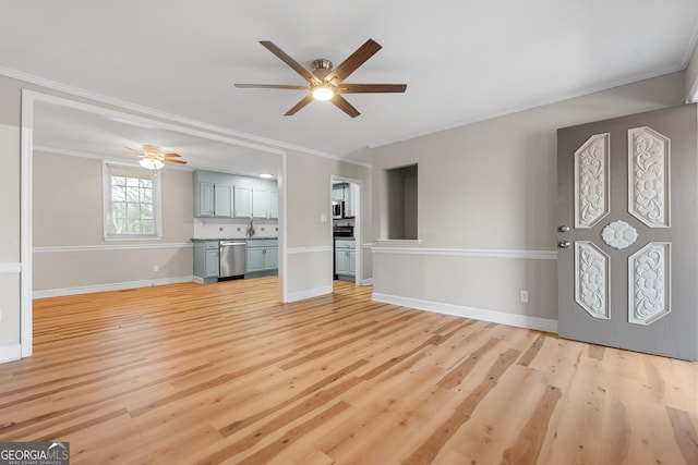 unfurnished living room with crown molding, ceiling fan, and light wood-type flooring