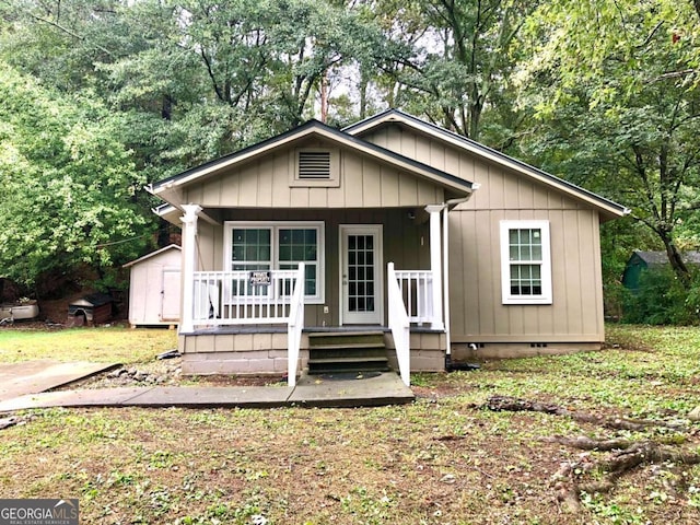 view of front of property with a shed and a porch