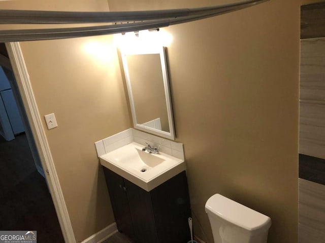 bathroom with vanity and toilet