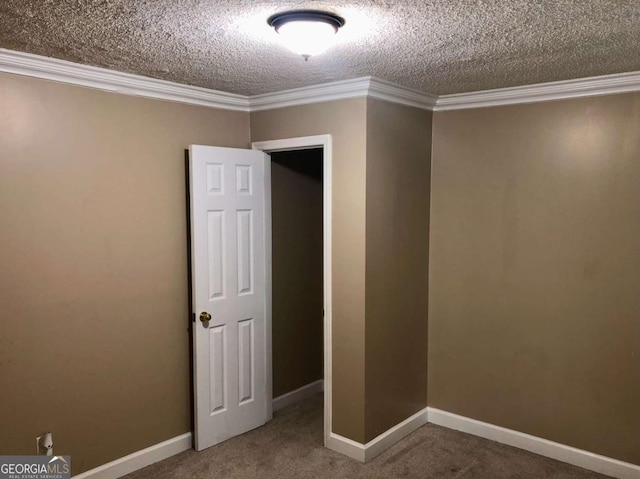 empty room with crown molding, carpet flooring, and a textured ceiling