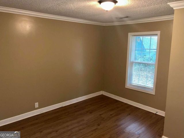 empty room featuring ornamental molding, a textured ceiling, and dark hardwood / wood-style flooring