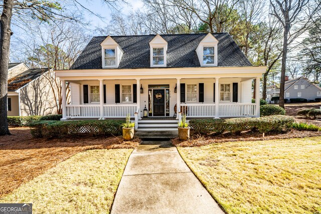 new england style home featuring covered porch