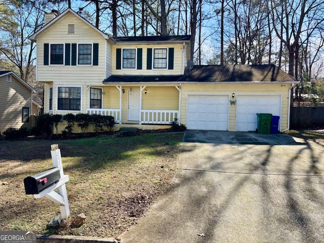 view of front property featuring a porch, a garage, and a front yard