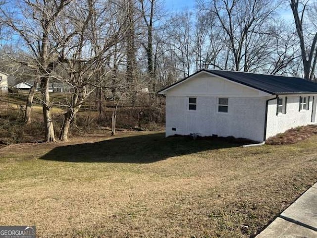 view of property exterior with a lawn