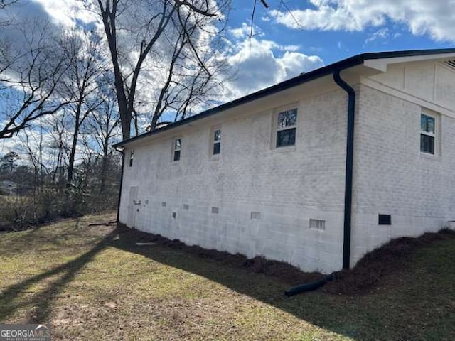 view of property exterior with a lawn