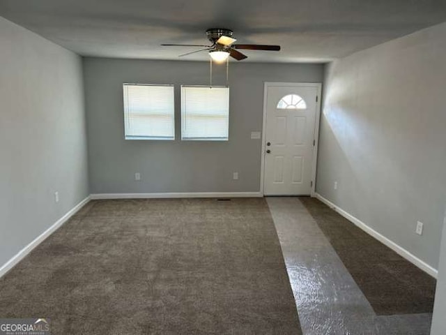 carpeted entrance foyer with ceiling fan