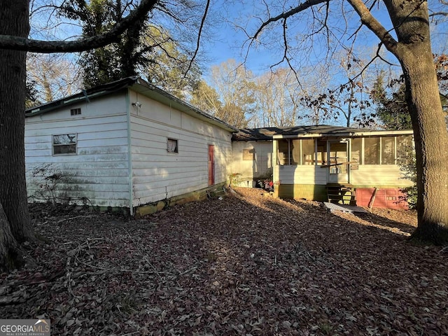 back of house featuring a sunroom