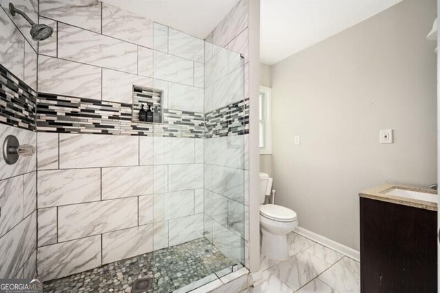 1574 Mayflower St, Atlanta, GA 30311 - full bath with marble finish floor, toilet, vanity, baseboards, and a stall shower