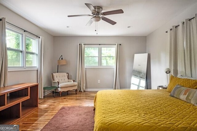 1574 Mayflower St, Atlanta, GA 30311 - bedroom with baseboards, wood finished floors, ceiling fan, and multiple windows
