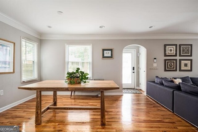 1574 Mayflower St, Atlanta, GA 30311 - dining space featuring arched walkways, ornamental molding, wood finished floors, and a wealth of natural light