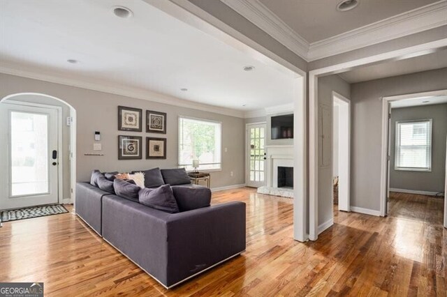 1574 Mayflower St, Atlanta, GA 30311 - living area with arched walkways, wood finished floors, crown molding, and a large fireplace