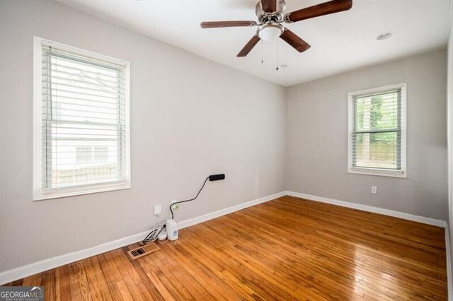 1574 Mayflower St, Atlanta, GA 30311 - unfurnished room featuring light wood-type flooring, baseboards, ceiling fan, and visible vents