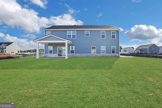 back of house featuring a yard