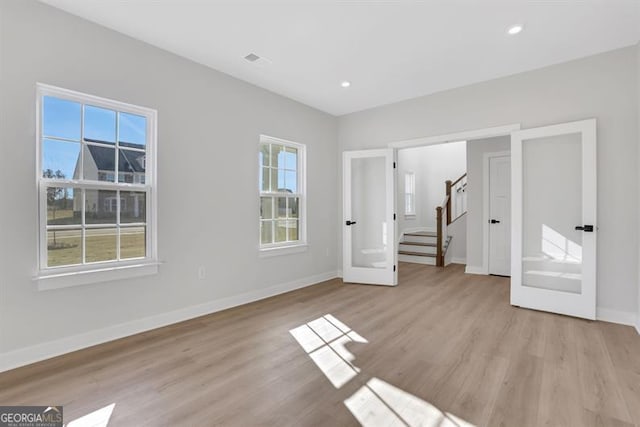 empty room with light hardwood / wood-style flooring