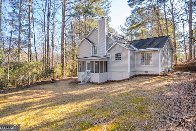 back of property with a yard and a sunroom