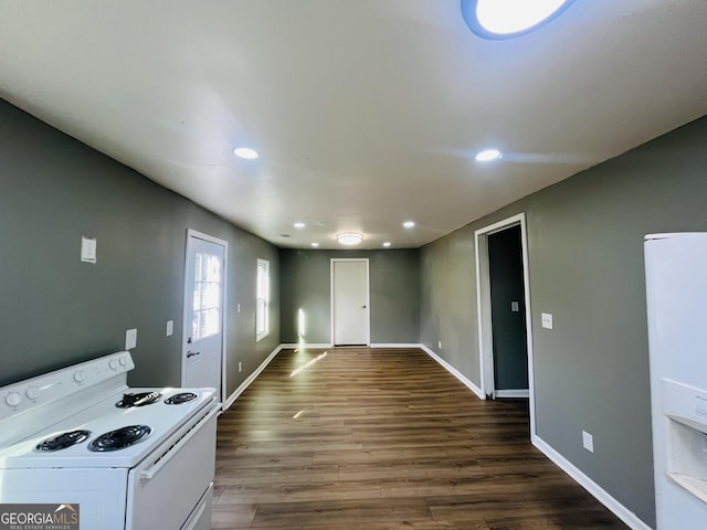 kitchen featuring white cabinets, dark hardwood / wood-style floors, and white range with electric stovetop