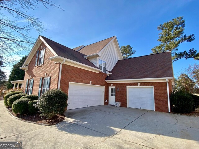 view of side of home with a garage