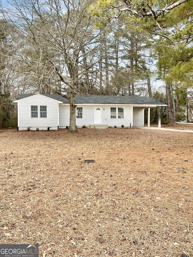 ranch-style house featuring a carport