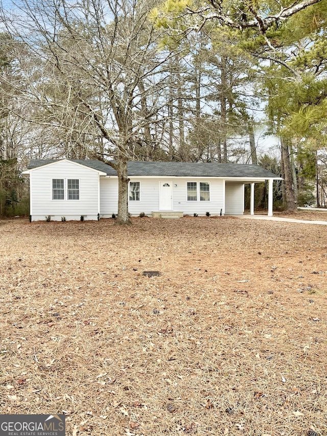 ranch-style house featuring an attached carport