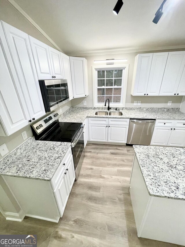 full bathroom featuring tiled shower / bath combo, vanity, hardwood / wood-style floors, and toilet