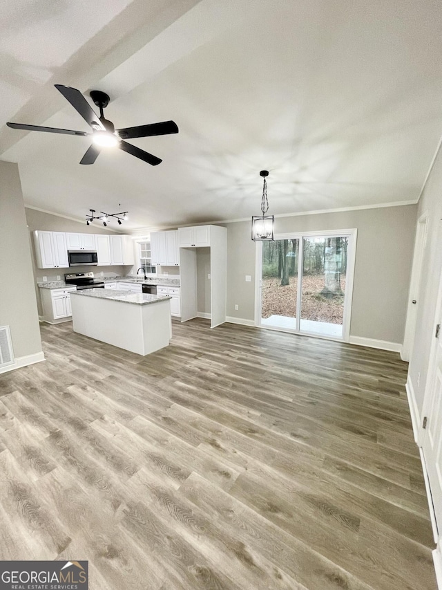 unfurnished living room featuring ceiling fan with notable chandelier, ornamental molding, and light hardwood / wood-style floors