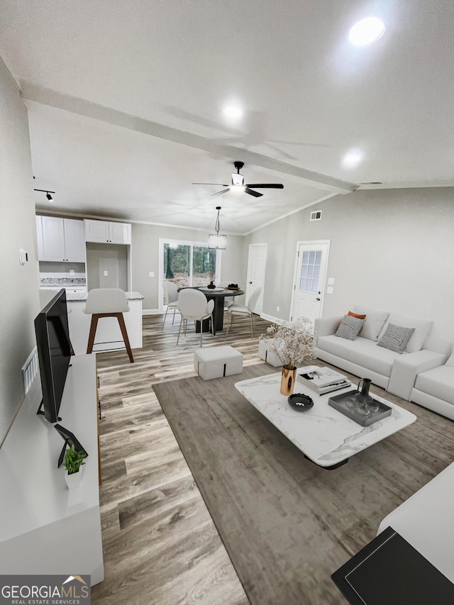 living room featuring visible vents, ceiling fan, light wood-style flooring, and baseboards