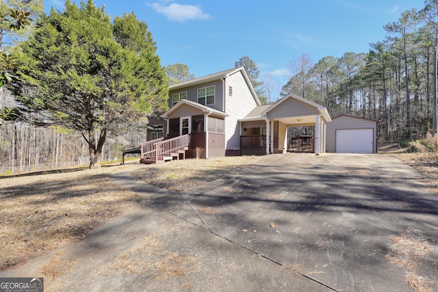 view of front facade with an outbuilding, a porch, and a garage