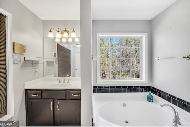 bathroom with vanity and a tub