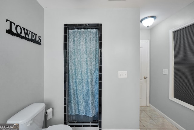 bathroom with walk in shower, tile patterned floors, and toilet