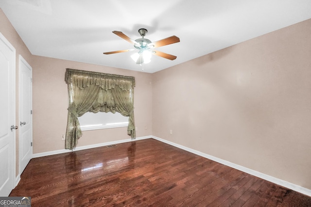 spare room with hardwood / wood-style flooring and ceiling fan