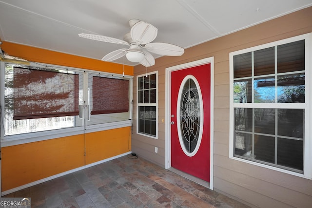 view of exterior entry featuring ceiling fan