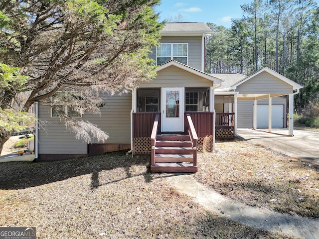 view of front of home featuring a carport, a garage, and covered porch