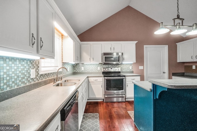 kitchen featuring pendant lighting, sink, stainless steel appliances, and white cabinets